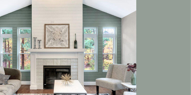 This paint color, Benjamin Moore Sea Glass CSP-735, is shown in a large family room on the fireplace wall, accened by horizontal white shiplap. It's a medium shade, with cooler gray. undertones.