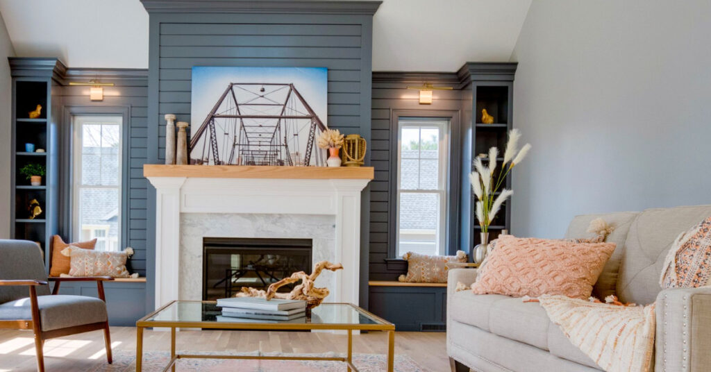 Built-in shelves and shiplap fireplace wall painted in Ocean Floor by Benjamin Moore, featured in The Cape House by Kadilak Homes.