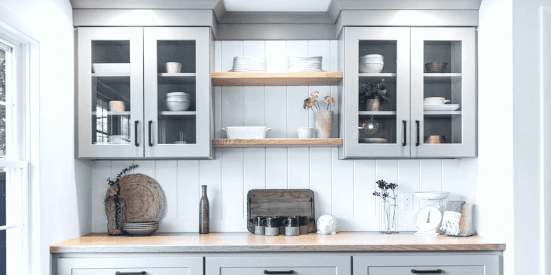 Bar cabinets with glass doors and wood counter top