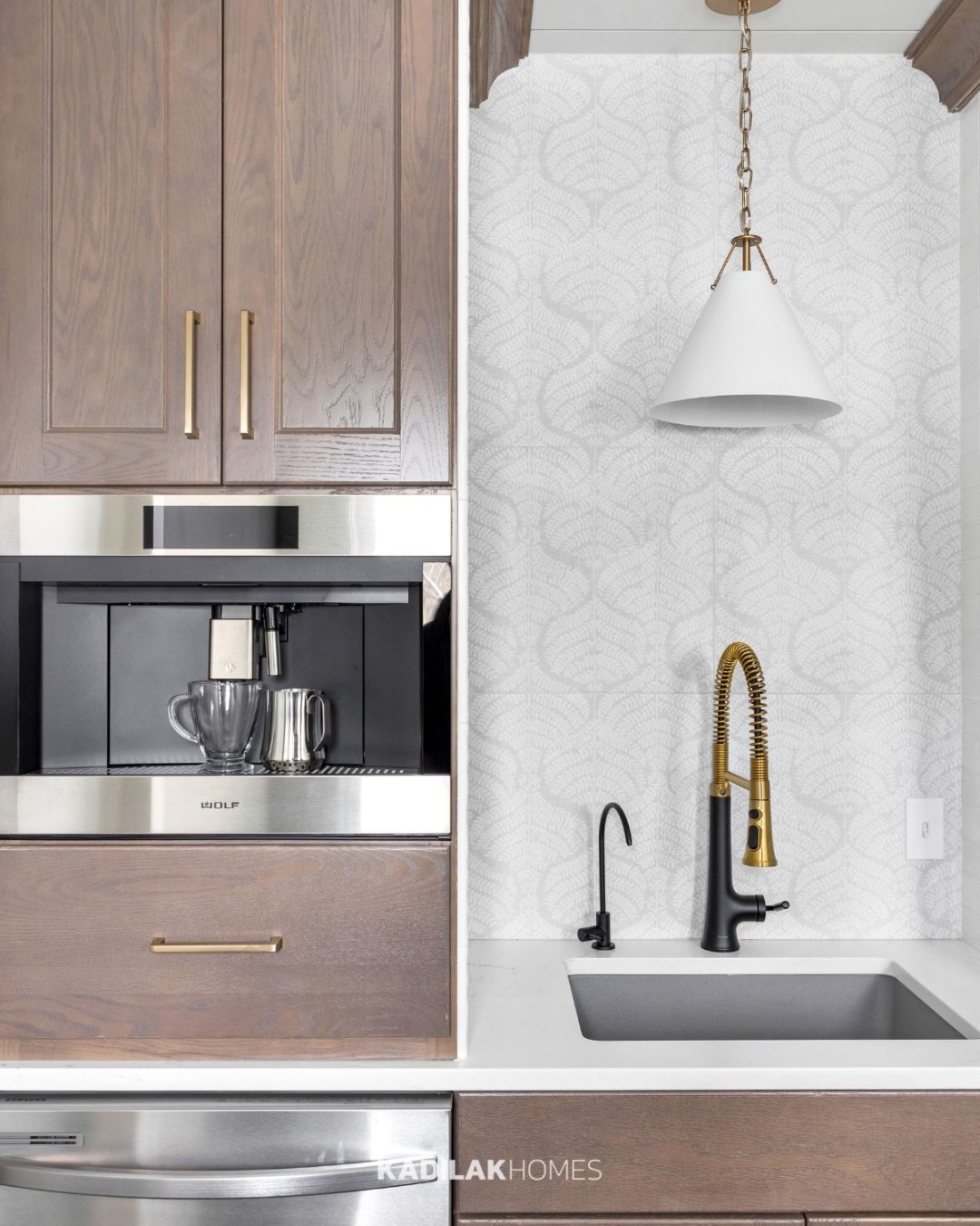 Xavier Mini Pendant by Crystorama with a white metal cone shade and brass accents hanging above a prep sink in a custom kitchen.