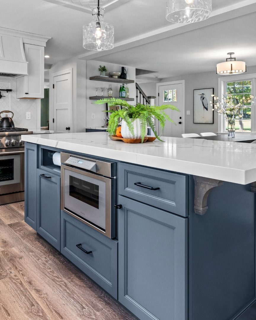 Modern kitchen island design. Britannia Blue 1623 Benjamin Moore deep navy blue paint color perfect for navy blue kitchen walls and bold coastal home design