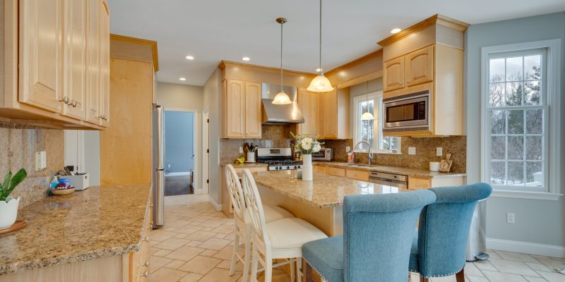 1990s maple kitchen, small kitchen, small island, cramped kitchen layout, kitchen with angled bay and slider