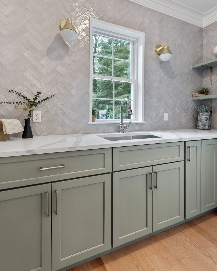 Coastal kitchen pantry cabinets in Escape Gray by Sherwin Williams featuring soft blue gray tones, white quartz countertops, and a light beachy aesthetic in a custom coastal home