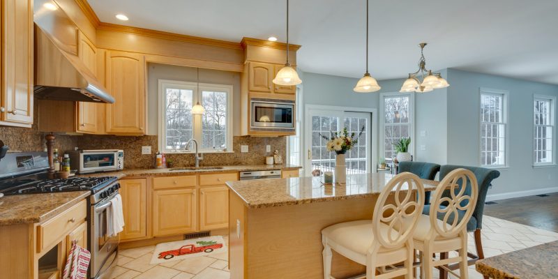 1990s maple kitchen, small kitchen, small island, cramped kitchen layout, kitchen with angled bay and slider