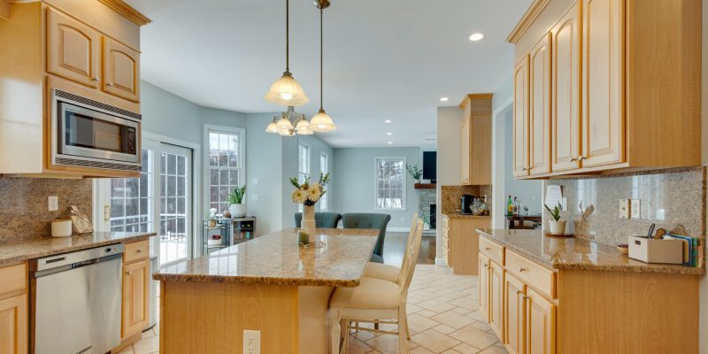 1990s maple kitchen, small kitchen, small island, cramped kitchen layout, kitchen with angled bay and slider