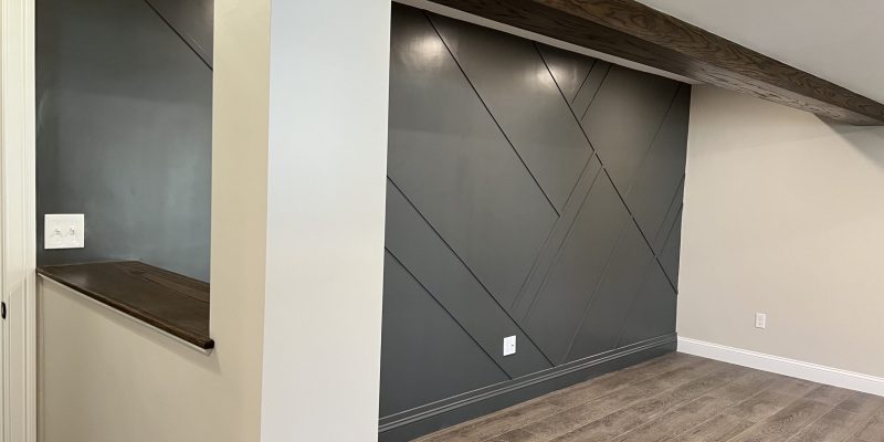 Basement accent wall idea painted with Benjamin Moore Kendall Charcoal HC-166 and oak beam stained with Minwax Jacobean