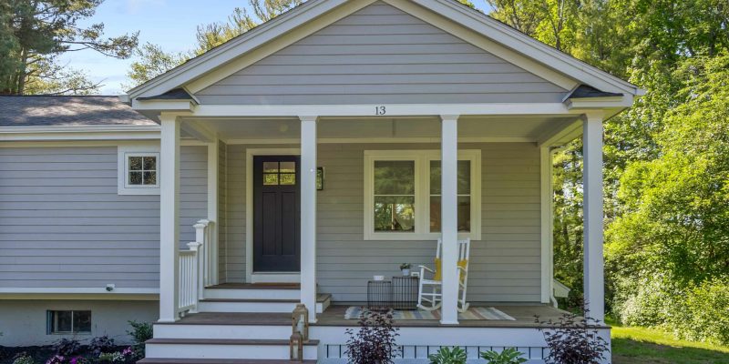 Single story home with front porch, A-frame roof, square columns, no railings, and James Hardie plank siding in Light Mist