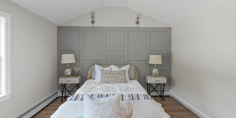 Master bedroom accent wall with paneling, gray accent wall with sconces, primary bedroom with vaulted ceiling ideas