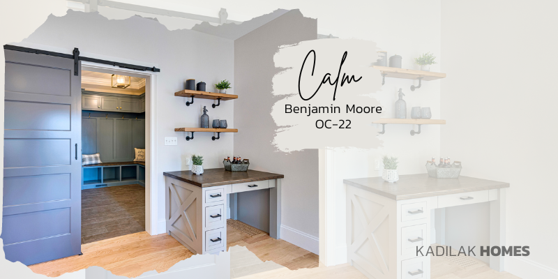 kitchen with built in desk featuring benjamin moore calm oc-22 paint color, reclaimed wood desk top and barn door to the mudroom