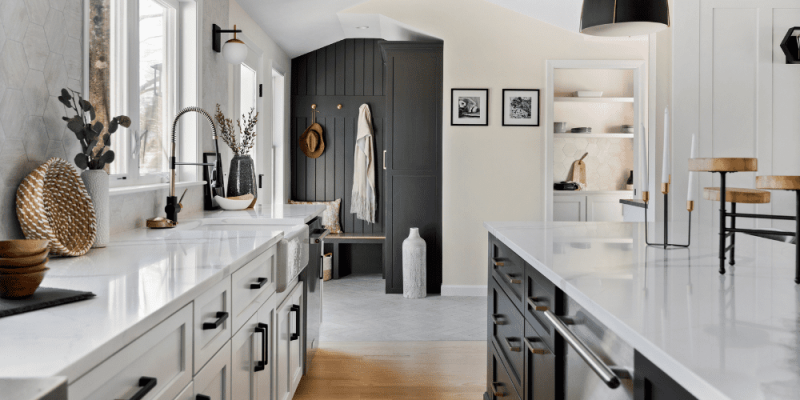 Black and White modern kitchen design with charcoal gray wood panelling, walk-in butler's pantry, black hardware, and hexagon tile
