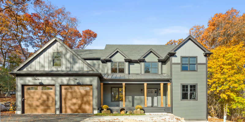 hardie plank siding iron gray, gray slate. Dark siding colors, dark house exterior ideas, siding ideas, house with black trim. Cloplay walnut garage door with arch windows, cedar posts for front porch, front porch ideas, metal roof over front porch, board and batten siding