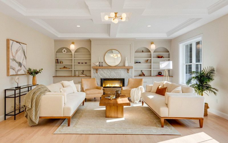 Close-up of two copper wall sconces with glass shades, highlighting warm metallic accents in a modern home.