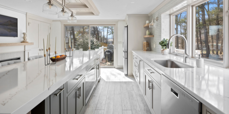 Essential kitchen renovation tips, kitchen budget tips, kitchen with plank tile floor and dark green island, 2