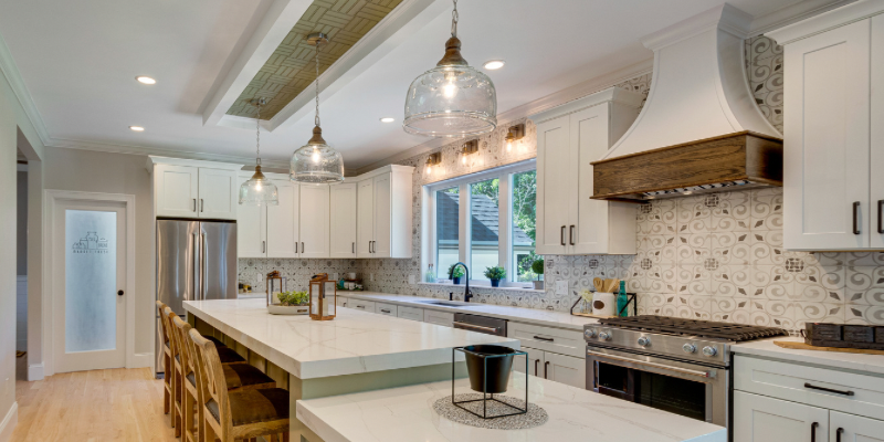 Kitchen island with green cabinets, 2” mitre countertops, basketweave coffered ceiling pattern
