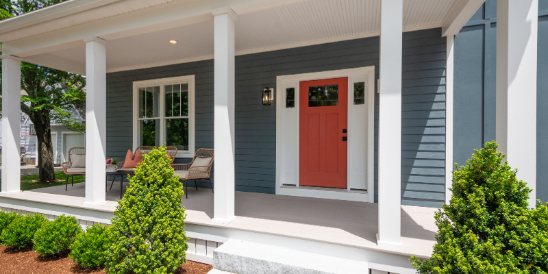 Front porch with no railings, white square posts, front door Benjamin Moore iron ore red, James hardie siding evening blue, front porch ideas
