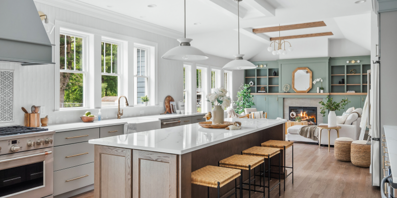 kitchen next to family room, kitchen with wood island, taupe cabinets and wood island, chevron coffered ceiling, open kitchen and family room, kohler artifacts single handle faucet modern brass, benjamin moore carolina gull, fireclay tile kabuki sphere