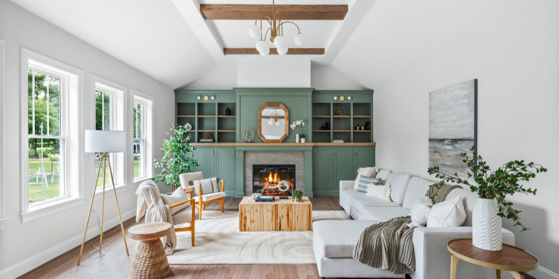 fireplace wall with built in storage and bookcases, family room with ceiling beams, cabinets flanking fireplace, benjamin moore carolina gull, nature inspired design, earthy tones