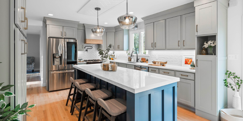 Essential kitchen renovation tips, kitchen budget tips, kitchen with wet elm lighting pendants and light green blue cabinets, blue island kitchen design, surviving a kitchen renovation