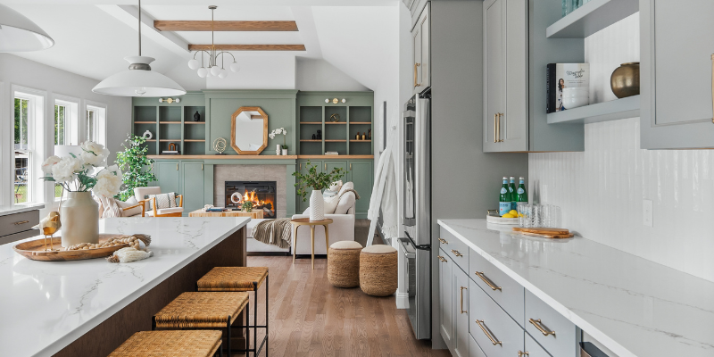 new home with open kitchen and family room, benjamin moore carolina gull, wayfair giles pendant, msi calacatta arno quartz countertops