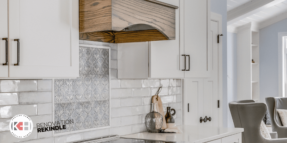 hood with oak, navy pattern tile, tile over stove, inlay over stove, white subway tile, liberty artesia handles, range hood with wood trim, white kitchen range hood ideas