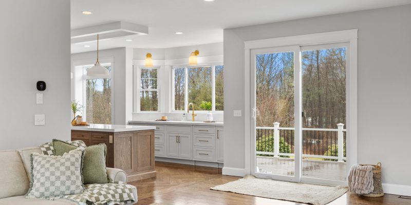 kitchen with oak wood island, paneled appliances, inset cabinets, neutral color scheme, henry sconces, henry pendants, odd shaped kitchen, weird kitchen layout, kitchen sink in bay, large picture window, benjamin moore Cloud Cover OC-25, kohler artifacts kitchen faucet, kohler artifacts bar faucet
