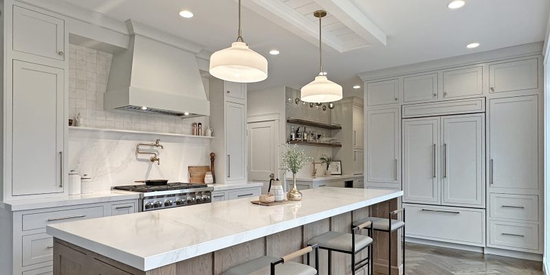sunlit kitchen renovation wet bar with kohler artifacts bar faucet, inset cabinets, oak shelves with brushed gold rail and ball sconces, built in pantry with coffee maker storage and under counter refrigerator